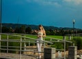 Girl in white walks in the summer garden.