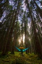 Girl who loves to travel relaxing in blue hammock into the Bavarian forest from Germany Royalty Free Stock Photo