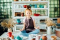 Girl wih many cups made from clay sitting in pottery studio Royalty Free Stock Photo