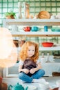 Girl wih many cups made from clay sitting in pottery studio Royalty Free Stock Photo