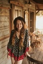 Girl in the Wild West, in Western house. Girl in hat with long cerly hair smile. Beautiful pretty girl in black hat. Incredible Royalty Free Stock Photo