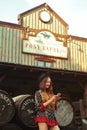 Girl in the Wild West, in Western house. Girl in hat with long cerly hair. Beautiful pretty girl taking selfie.