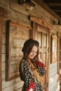 Girl in the Wild West, in Western house. Girl in hat with long cerly hair smile. Beautiful pretty girl in black hat. Incredible Royalty Free Stock Photo