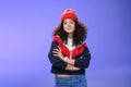 Girl will show winter who boss. Confident and stylish self-assured attractive woman with curly hair in cute red beanie Royalty Free Stock Photo