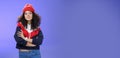 Girl will show winter who boss. Confident and stylish self-assured attractive woman with curly hair in cute red beanie Royalty Free Stock Photo
