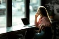 Girl by the window in a cafe