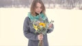 Girl in winter with a bouquet of flowers in hands.Slow motion