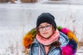 Girl in winter clothes. Girl 10 years old. Teenager in blue jacket. Girl on a walk in a hat