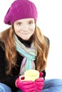 Girl in winter clothes holding cup of warm cure