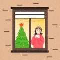 A girl on a winter day looks out the window from the house. Cozy interior with a Christmas tree. Festive New Year Royalty Free Stock Photo