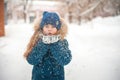 Girl in the winter forest close-up and copy space. A child plays in the winter with snow Royalty Free Stock Photo