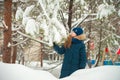 Girl in the winter forest close-up and copy space. A child plays in the winter with snow Royalty Free Stock Photo