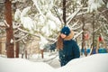 Girl in the winter forest close-up and copy space. A child plays in the winter with snow Royalty Free Stock Photo