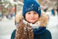 Girl in the winter forest close-up and copy space. A child plays in the winter with snow Royalty Free Stock Photo