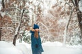 Girl in the winter forest close-up and copy space. A child plays in the winter with snow Royalty Free Stock Photo