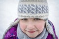 Girl in the winter forest close-up and copy space. A child plays in the winter with snow Royalty Free Stock Photo