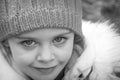 Girl in the winter forest close-up and copy space. A child plays in the winter with snow Royalty Free Stock Photo