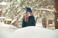 Girl in the winter forest close-up and copy space. A child plays in the winter with snow Royalty Free Stock Photo