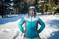 Girl in the winter forest playing snowballs