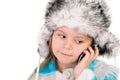 The girl in a winter fur cap speaks by phone Royalty Free Stock Photo