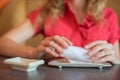 The girl wipes her hands with a hot towel rolled into a roll in a Japanese restaurant before eating Royalty Free Stock Photo