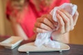 The girl wipes her hands with a hot towel rolled into a roll in Royalty Free Stock Photo