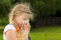 girl wipes a nose with napkin.children get cold and blow her nose.