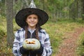 girl in witch costume holding pumpkin lantern, halloween concept, girl in the forest playing with jack lantern Royalty Free Stock Photo