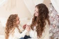 girl and woman congratulating happy new year in home at badroom