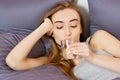 Girl woman drink water in bed at home, healthcare concept, hangover Royalty Free Stock Photo