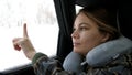 Pretty young woman hand touch drawn heart on frozen window in car at winter . 4k Royalty Free Stock Photo