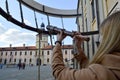 The girl, the woman looks in an old ancient telescope on the European medieval tourist building, the castle, the palace with spire Royalty Free Stock Photo