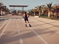 Girl or woman with rollerblade at sunset along the way in the poetto beach in Cagliari - Sardinia - Italy