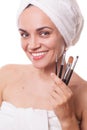 Girl woman in towel with makeupbrushes in hand isolated Royalty Free Stock Photo