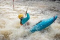 Girl, women in kayak sails mountain river. Whitewater kayaking, extreme sport rafting. Ireland. Europe