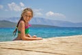 Girl by the wooden pier in the sea Royalty Free Stock Photo