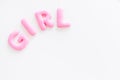 Girl word as decoration for baby shower on white background top view frame copy space