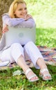 Girl work with laptop in park sit on grass. Natural environment office. Woman with laptop work outdoors lean tree Royalty Free Stock Photo