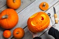 Girl worked on wooden table with pampkin for halloween