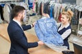 Girl worker Laundry man gives the client clean clothes Royalty Free Stock Photo