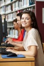 Girl working on computer in library Royalty Free Stock Photo
