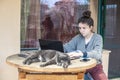 A girl is working on the laptop while the cat is resting Royalty Free Stock Photo