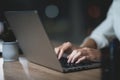 Girl is working late in the dark office with a laptop. Young beautiful businesswoman girl in office. Royalty Free Stock Photo