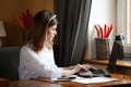 The girl works at the computer in a cafe Royalty Free Stock Photo