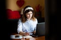 The girl works at the computer in a cafe Royalty Free Stock Photo