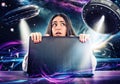 Girl works on the computer surrounded by UFOs. Concept of internet espionage and security