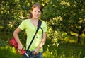 Girl works with grass-cutter