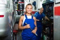 Girl in workwear in auto mechanic workshop Royalty Free Stock Photo