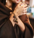 Girl wrapped in a cozy brown plaid with a cup of drink in her hands. An atmosphere of relaxation and reflection. Royalty Free Stock Photo