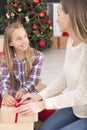 Girl wrapping christmas gift box